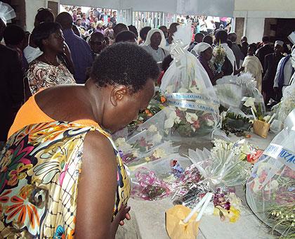 A mourner pays respect to those who were laid to rest last sunday.  The New Times / J.P. Bucyensenge .