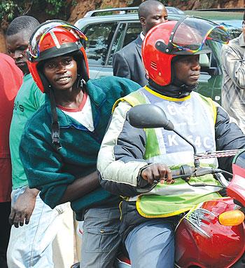 A Motocyclist and a passenger. Operators are still reluctant to use smart covers. The New Times / File