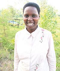 Immaculate Nyirampore, Vice President of u2018Mpore dukunde inzukiu2019, at the bee keeping site, Nyanza district. The New Times / D. Umutesi.