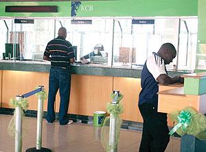 A client carrying out transaction at one of the banks in Kigali. The New Times / File.