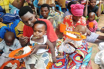 Mothers in Butamwa Sector, Nyarugenge District, feed their babies on a balanced diet during the Womens Day celebrations yesterday. The New Times / John Mbanda.