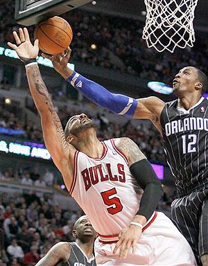 Orlando Magic center Dwight Howard (12) blocks the shot of Chicago Bulls forward Carlos Boozer during the second half of an NBA game. Net photo.