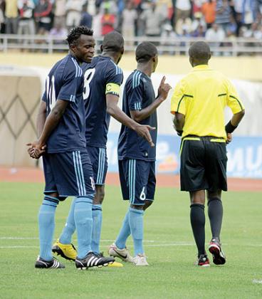 Police players argue with a match official during their game with Rayon Sport on Sunday. The clubu2019s title hopes suffered a blow after a 2-2 draw The New Times/T. Kisambira.