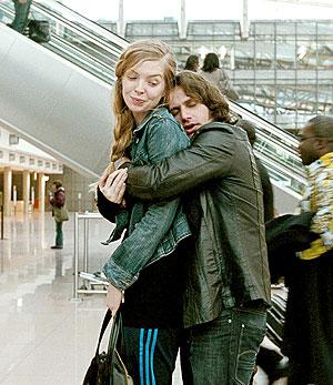 Zinos clings onto girlfriend Nadine.