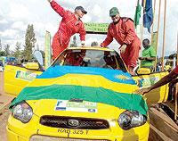 Davite Giancarlo (right) and his female navigator Sylvia Vindevogel celebrate their KCB Mt. Gorilla rally runner up success last year. The New Times/File.