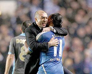 Chelsea's caretaker manager Roberto Di Matteo hugs Drogba following their remarkable comeback. Net photo.