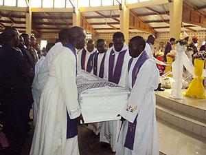 Priests carry the casket containing the body of Bishop Misago yesterday.  The New Times / JP Bucyensenge.