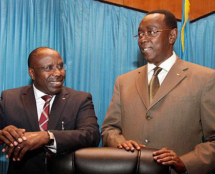Dr Habumuremyi (L) chats with Bernard Makuza, Vice President, Senate, on the formeru2019s arrival at Parliament yesterday. The New Times / Timothy Kisambira.