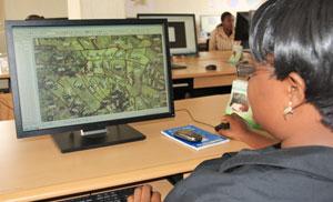 A staff member digitalising maps of land parcels. The New Times / Courtesy.