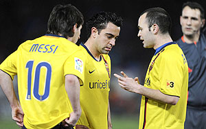 AT THE CENTRE; Messi, Xavi and Iniesta