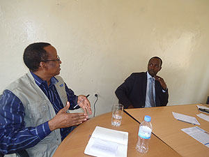 WFP's  Abdoulaye Balde (L) chats with Governor Munyentwari. The New Times / JP Bucyensenge.