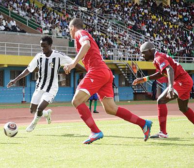 Dan Wagaluka who was impressive for APR vies past two ESS players yesterday at Amahoro stadium. The Sunday Times uf022/ T. Kisambira.