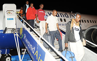 The students disembarking a RwandAir flight after they were evacuated last year. The New Times / File.