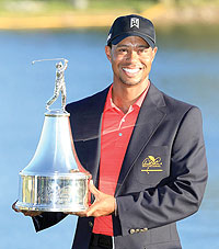 Tiger Woods proudly holds the trophy during the final round of the 2012 Arnold Palmer Invitational. Net photo.
