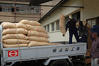 Workers offload Kabuye sugar. More imports will keep prices low. The New Times/ File.