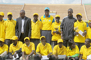 Last yearu2019s Kigali Peace Marathon winners in the different categories pose for a group photo with Sports and Culture Minister Protais Mitali (standing centre in cap). The New Times/File.