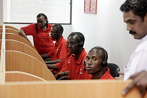 AT YOUR SERVICE:  Airtel workers attending to clients from a call centre yesterday. The New Times / Timothy Kisambira. 