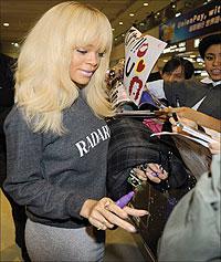 Casual arrival: Rihanna lands in Japan wearing a comfortable dark grey sweater and  a light grey skirt . Net photo