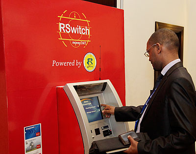 A man operates an ATM at Serena Hotel during a recent Cyber workshop in Kigali. The New Times / file.
