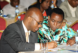 NISR Director General Yusuf Murangwa (L) explains to Minister Aloysea Inyumba at the meeting on Tuesday.  The New Times / John Mbanda.