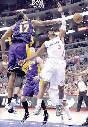 Andrew Bynum blocks the shot of Chris Paul during a 113-108 Laker win at Staples Center in Los Angeles, California. Net photo.