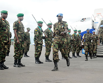 RDF peacekeepers arrive at Kigali International Airport, from Darfur, aboard a RwandAir flight, where they were welcomed by the Army Chief of Staff, Lt. Gen. Caesar Kayizari (2nd left) and the Commandant of General Headquarters, Brig. Gen. Augustine Turag