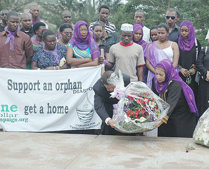 Mourners lay wreaths at a memorial site . The New Times / File.