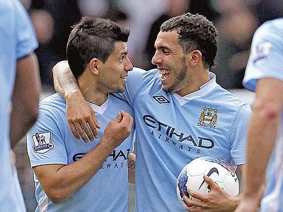 Aguero and Tevez enjoy Manchester City's 6-1 victory at Carrow Road in the early kick-off on Saturday.