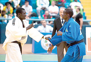 Yannick Uwase (right) fights with Chadu2019s Mazou Abaker Mbairo in 73kg category at the London Olympics Games qualifying tournament in Algeria. The New Times/Courtesy.