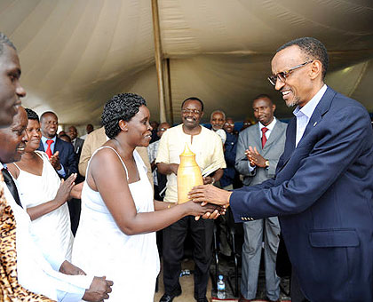 President Paul Kagame receives a gift from a resident of Kinazi, Ruhango District, yesterday. The New Times/ Village Urugwiro.
