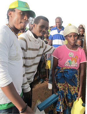 A Genocide widow in Nyakibirizi sector receives donations from the artistes.