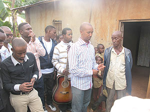 Joseph Mushyoma, boss of the East African Promoters (clad in a striped shirt) chats with a Genocide survivors.