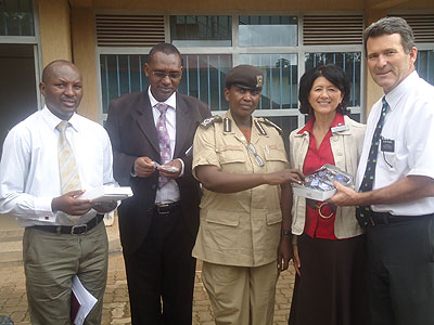 The Head of DIC in Rwanda, Brad Wilkers (R) while handing over some of the spectacles to Mary Gahonzire. The New Times / Timothy Kisambira.