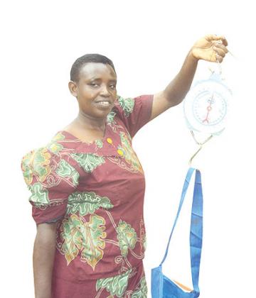 Agnes Uyisabye shows off the materials that she uses in her work as a community health worker.  The New Times / J P.  Bucyensenge.