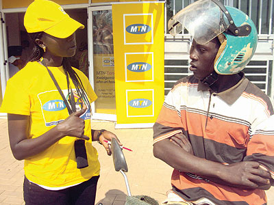 An MTN Rwanda staff explains to a motocyclist about the company. The New Times / File.
