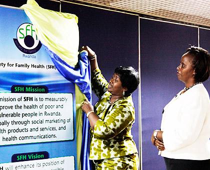Health minister Dr. Agnes Binagwaho unveils a banner at the launch of the NGO. The Sunday Times/ T. Kisambira.