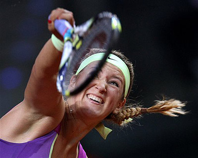 Belarus' Victoria Azarenka serves against Poland's Agnieszka Radwanska. Net photo.