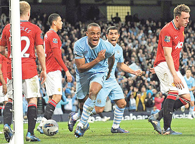 CAPTAIN MARVEL ... Vincent Kompany (C) runs away in delight after scoring for City. Net photo.