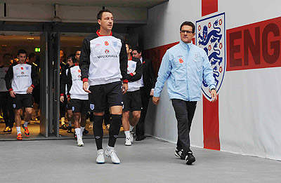 Fabio Capello (R) quit as England coach over John Terry's revoked captaincy. Net Photo.