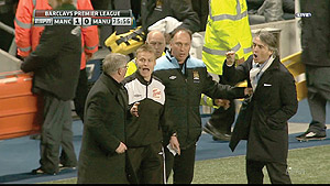 NEW RIVALRY: Officials appeal for calm between Sir Alex Ferguson (L) and Roberto Manchini during last Mondayu2019s game. Net photo. 