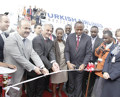 L-R The Deputy Governor of Istambul, Dr Temel Kotil, the CEO, Turkish Airlines and Ministers Louise Mushikiwabo and Albert Nsengiyumva cut the ribbon at the airliner's maiden flight to Kigali yesterday.  The New Times / Timothy Kisambira.
