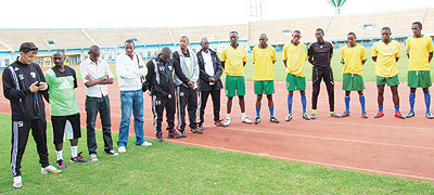 Amavubi players and staff pay their respect to fallen teammate Patrick Mafisango yesterday at Amahoro stadium. The New Times/E. Niyonshuti.