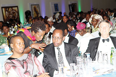 John Gara (2nd R) RDB CEO, listens to Sandra Idossou of the Service Magazine while Clementine Vervelde Murekatete (L) looks on.