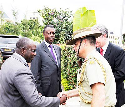 . Prime Minister Dr Pierre Damien Habumuremyi greets Colonel James Davey, Australian Defence Attache, African Union, as Defence Minister General James Kabarebe looks on during a UN Senior Mission Leaders Course held in Kigali on Monday. The Sunday Times /