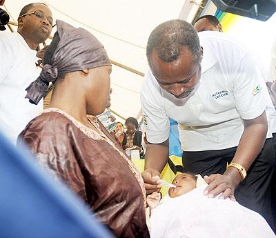 The Permanent Secretary in the Ministry of Health Dr. Uziel Ndagijimana vaccinates a baby at the launch of the Rota virus vaccine in Gataraga Musanze District on Friday.  The Sunday Times/ John Mbanda