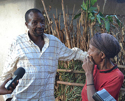 Costasie Nyirashishi (R) stares at her son Augustin Murego whom she had not seen in 25 years. The New Times / JP Buchensenge.