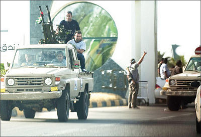 Libyan government forces arrive at Tripoli international airport to join in negotiations with the Al-Awfya brigade who overran the airport few hours earlier on Monday. Net photo.