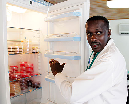 Captain Athere Murangwa, a biomedical technician showing some of lab samples. The New Times / Timothy Kisambira.