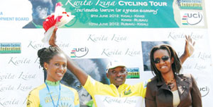 WINNERu2019S JOY: Abraham Ruhumuriza celebrates his victory alongside RDB's Head of Tourism Rica Rwigamba (right). Ferwacy photo.