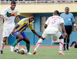 Labama Bokota wriggles through the Benin defenders during yesterday's FIFA 2014 World Cup qualifier played at Amahoro stadium which ended 1-1. The New Times; T. Kisambira